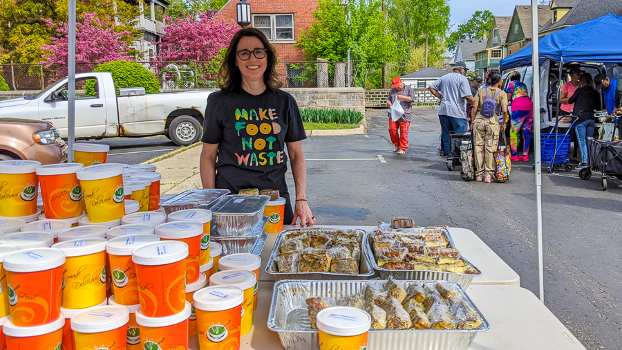 Photo of volunteer with food at distribution